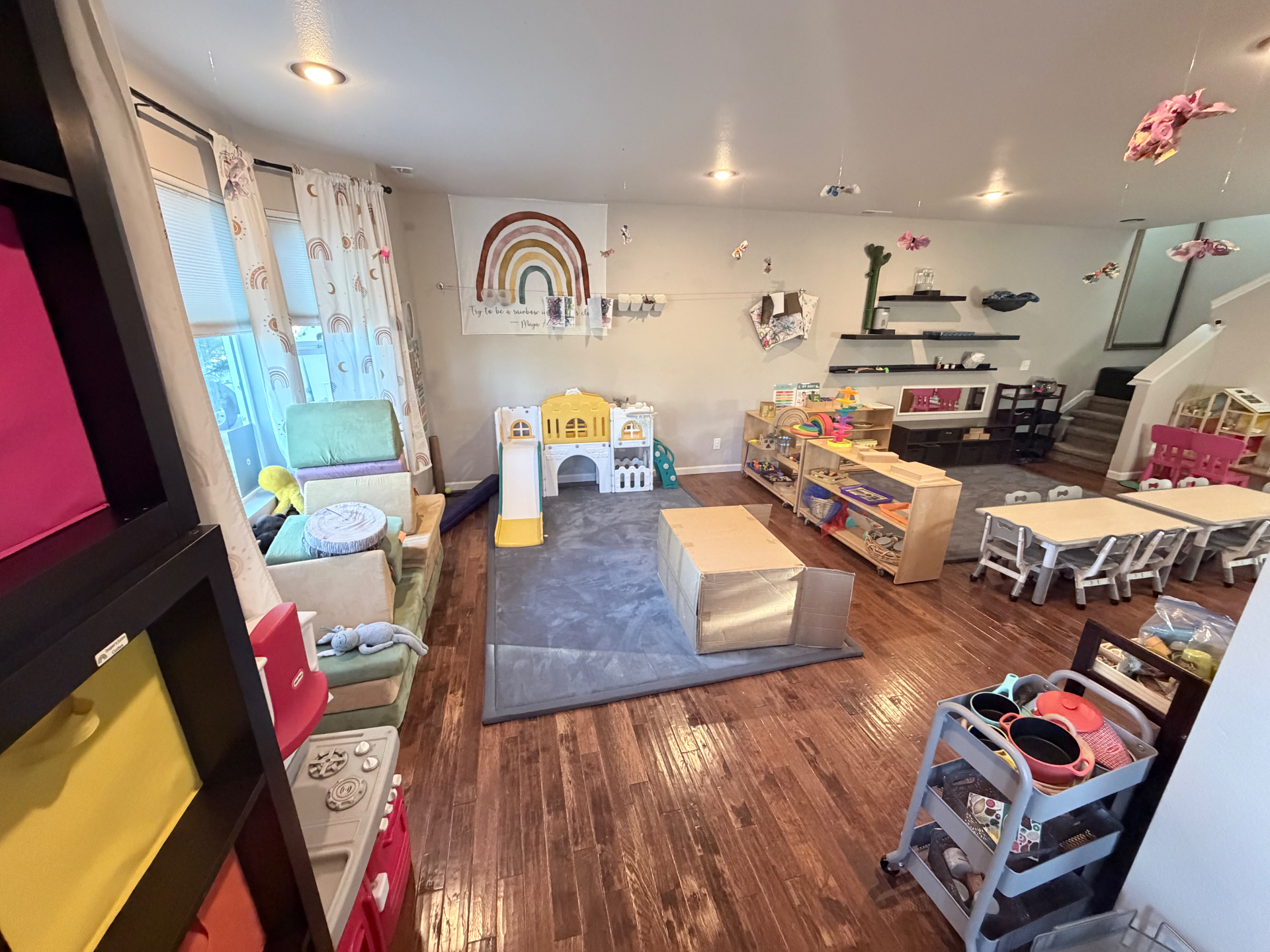The classroom's play corner with a soft castle, cushioned seating, and open shelves of materials